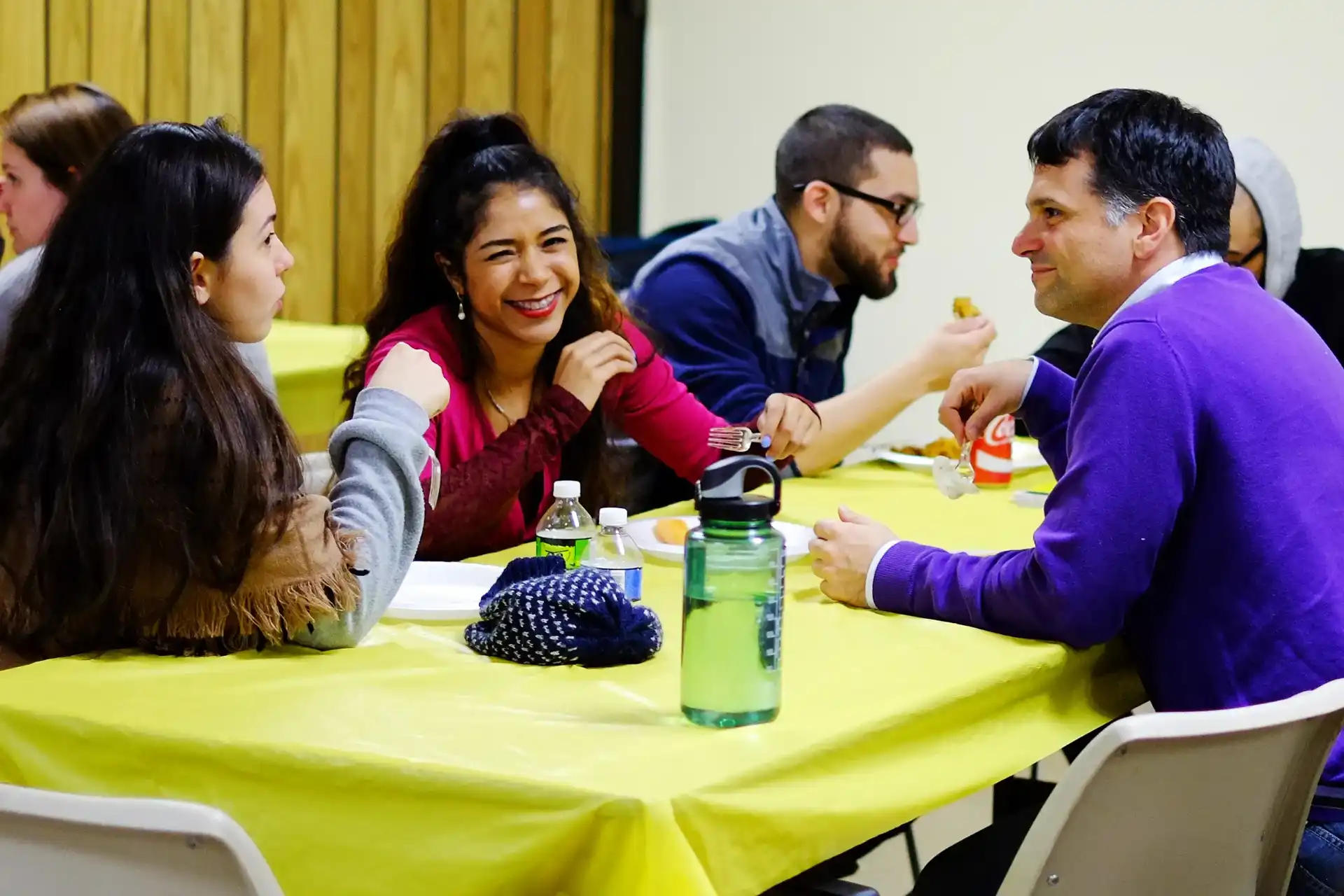 Students in conversation over dinner before class.
